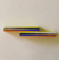 a piece of wood with a rainbow colored stripe on it