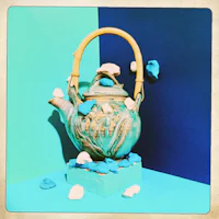 a teapot on a blue background