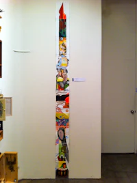 a tall piece of art on a wall