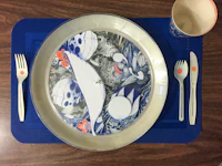 a blue plate with a fish on it