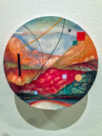a painting of a circular piece of art hanging on a wall