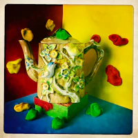 a teapot on a colorful background