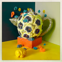 a teapot with flowers on it