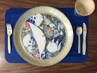 a blue plate with a fish on it